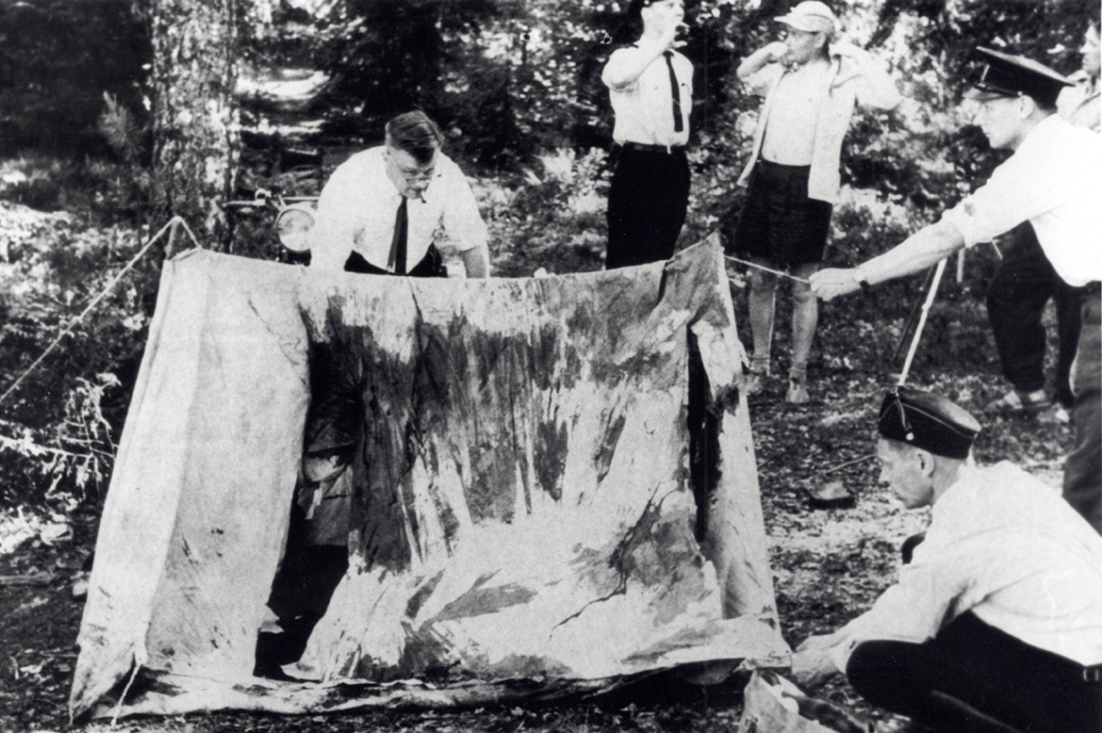 Police officers examining the collapsed tent at the Lake Bodom murder scene in 1960